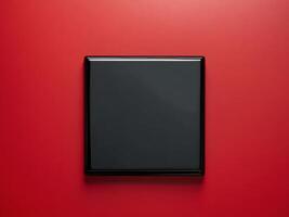Black Square Object on Vibrant Red Background for Dynamic Visuals photo