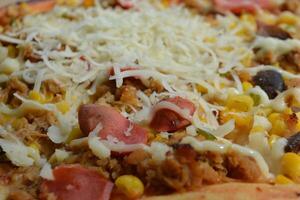 Delicious pizza with topping sausages, cheese, and corn, delicious meal to eat photo