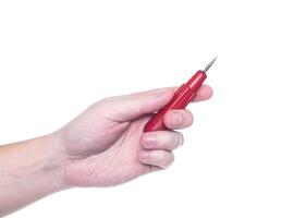Man holds an awl in his hand on a white background, isolate. Close-up, production photo