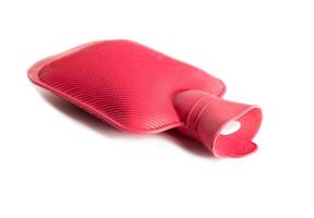 Red medical heating pad with hot water on a white background, isolate. Close-up, object photo