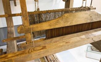 Old loom. Device for the manufacture of textile products, close-up, traditional photo
