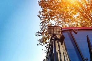 Rear lights in the tractor for traffic safety and illumination against the background of an autumn tree and a blue sky. Copy space for text photo