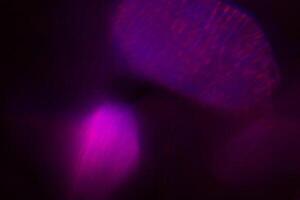 Blurred lens flare. Defocused colorful lights. Shiny glowing spots, abstract background and texture photo
