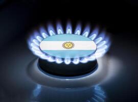 Burning gas burner of a home stove in the middle of which is the flag of the country of Argentina. Gas import and export delivery concept, price per cubic meter, transit, background photo