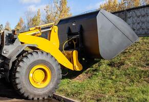 large bucket for loading wood chips mounted on a front-end loader, industry, unloading photo