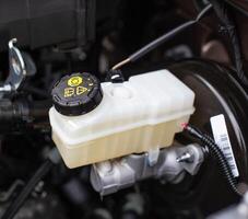 The tank with brake fluid in the car in the engine compartment. The concept of the working brake system, safety photo