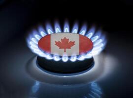 Burning gas burner of a home stove in the middle of which is the flag of the country of Canada. Gas import and export delivery concept, price per cubic meter, transit, background photo