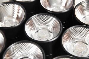 Spot overhead black lamps on a stretch ceiling on a white background. Lamps in the shape of a tube, close-up photo