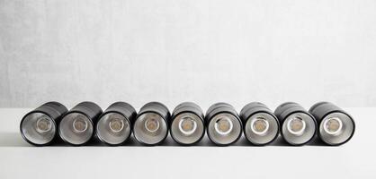 Spot overhead black lamps on a stretch ceiling on a white background. Lamps in the shape of a tube, close-up. Copy space for text photo