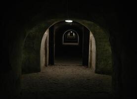 A long dark tunnel of a bomb shelter with a light at the end of the tunnel. Shelter of a bomb shelter in wartime. photo