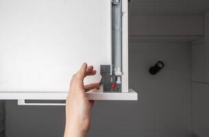 Kitchen drawer with full extension flush-mounted slides with Push to open system, close-up. Modern fittings photo