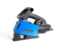 Powerful electric wall chaser for recessing in walls with two diamond blades for reinforced concrete. White background, isolate. Installer's power tool, close-up photo