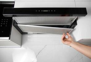 replacement of the grease filter in the kitchen hood. Copy space for text photo
