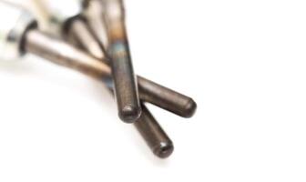 Modern ceramic glow plugs for warming up a diesel engine before starting. White background, isolate. Macro photo