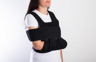 A girl in a medical brace on the shoulder joint for rehabilitation after a collarbone fracture and dislocation. Shoulder sprain, acromioclavicular joint photo