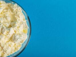 A plate with dry milk formula for feeding children on a blue background. Dry milk drink enriched with bifidobacteria. View from above. Copy space for text, healthy microbiota photo