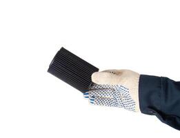 An auto mechanic holds in his hand an old dirty oil filter on a white background, isolate. Car oil and filter replacement concept, replacement schedule photo