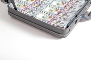Case with money bills of 100 dollars on a white background. Wealth, financial investment and investment concept, copy space for text. Criminal photo