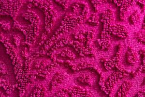 texture of burgundy terry towel with a pattern, close-up. Background photo