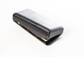 Bloated black power bank on a white background, isolate. Danger of power bank explosion, close-up photo