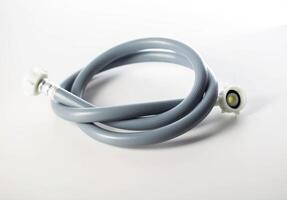 Gray twisted water hose from a washing machine on a white background, isolate, close-up photo