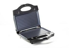 Black modern sandwich maker on a white background, isolate, close-up. Making toast and sandwiches photo