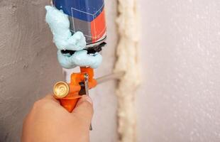 Construction foam gun with a defective cylinder. Foam bottle defect, close-up photo