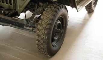 Part of the old soviet army car jeep. Restored retro car. Close-up photo