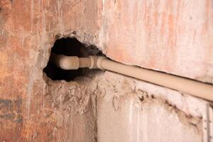 Polypropylene pipes in the wall of the bathroom when moving the heated towel rail. Copy space for text photo