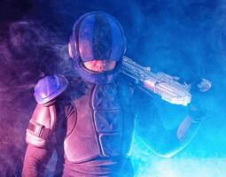 Cyberpunk future concept. Police officer reloads futuristic shotgun in dark. Robot aims at camera. Halfman bionic cyborg releases disconnector assembly of gun. Science fiction scene, fantasy, sci photo