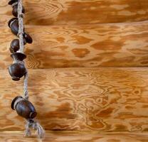 A beautiful decoration in a rustic wooden log house, clay pots are hanging on a rope. Copy space for text photo