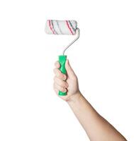 Construction roller for painting in a man's hand on a white background, isolate. Close-up, professional photo