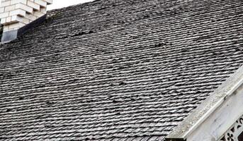 shingle roof. Old method of making roofs from wood, background. Copy space for text, architectural photo