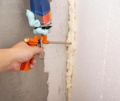 Construction foam gun with a defective cylinder. Foam bottle defect, close-up photo