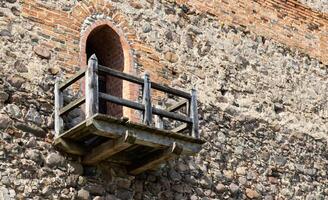 Balcony in the stone wall of an ancient castle. 14th century building. Copy space for text photo