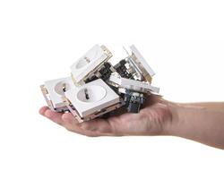 A man holds in his palm a lot of electrical sockets on a white background. Concept working electrician. Isolate photo