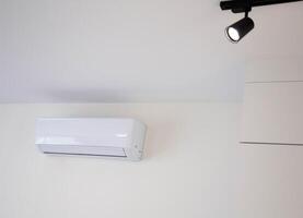 Modern wall-mounted air conditioner in the apartment with heating and cooling capacity of the room. Comfortable temperature. Copy space for text photo