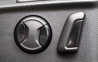Electric seat adjustment in a car. Backrest angle and seat height, macro photo