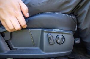 Mechanical adjustment of the height of the driver's seat in the car, close-up photo