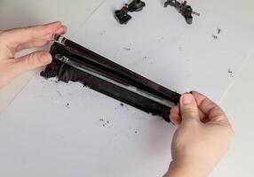 Disassembly of a drum cartridge on a white background. Cleaning and maintaining cartridge parts. Copy space for text photo