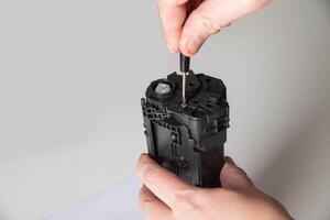 Disassembly of the printer cartridge for its maintenance and refilling with toner. White background, technology. Copy space for text photo