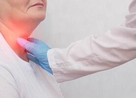 Adult woman on reception at the doctor who has problems with the thyroid gland and the endcrine system, close-up, patient photo
