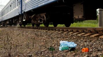 Rubbish on the railway thrown out of the train window, pollution, railway and litter photo