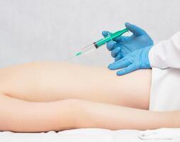 Doctor makes injection of trigger points on the girl s back, treatment of fibrosis and back pain, spondylosis photo