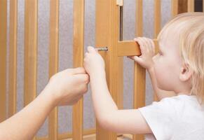 Mother and child are assembling a crib, close-up, caucasian, interior photo