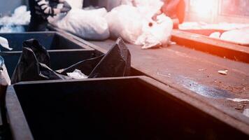 Workers select and sort garbage that travels on a conveyor belt in a waste recycling plant, environmental photo