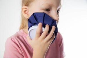 A seven-year-old girl applies a cold compress to a sore tooth. Relieving inflammation and pain in the tooth with cold, close-up. Local cryotherapy photo