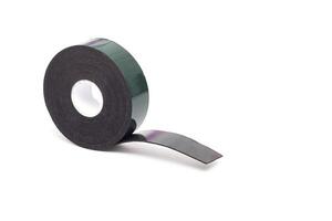 Reel of double-sided tape on a white background, isolate, green double-sided tape, close-up photo