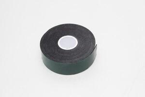 Reel of double-sided tape on a silver background, close-up, scotch tape photo