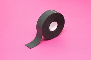 Reel of double-sided tape on a pink background, close-up, double-sided adhesive tape, element photo